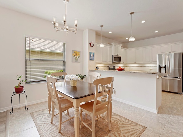 dining area featuring an inviting chandelier and light tile patterned floors