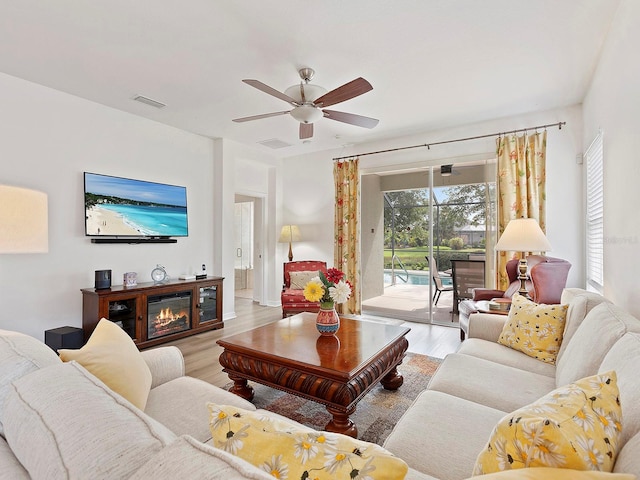 living room featuring ceiling fan and light hardwood / wood-style flooring