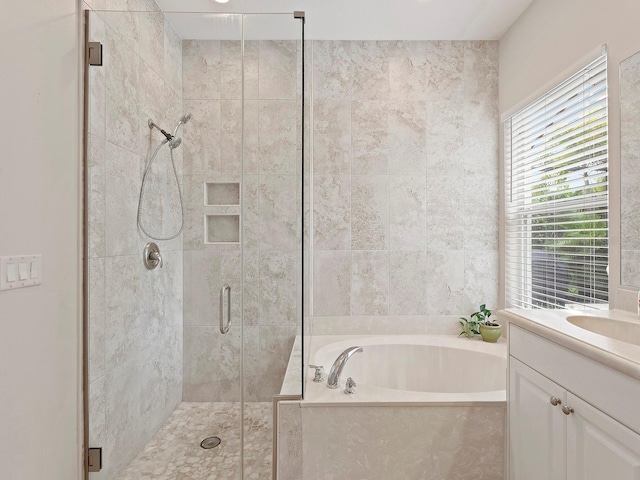 bathroom featuring separate shower and tub and vanity