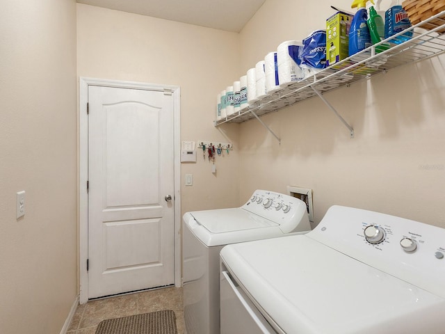 clothes washing area with light tile patterned floors and washing machine and clothes dryer