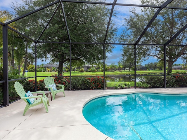 view of pool featuring glass enclosure and a patio area