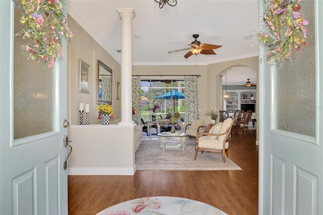 foyer with ceiling fan, crown molding, decorative columns, and wood-type flooring