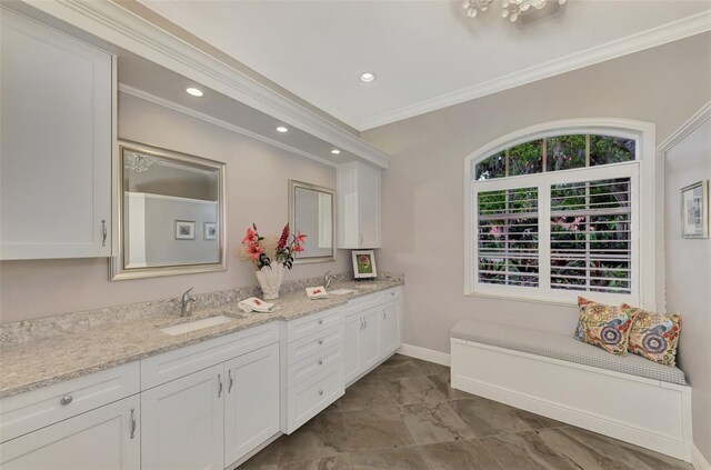 bathroom with ornamental molding, dual vanity, and tile patterned floors