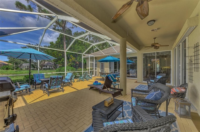 view of patio with ceiling fan, glass enclosure, and an outdoor living space