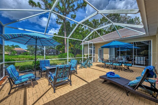 view of patio with an outdoor fire pit and a lanai