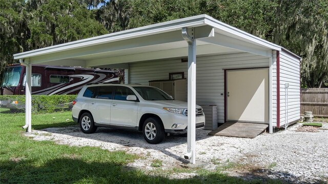 view of car parking with a lawn and a carport