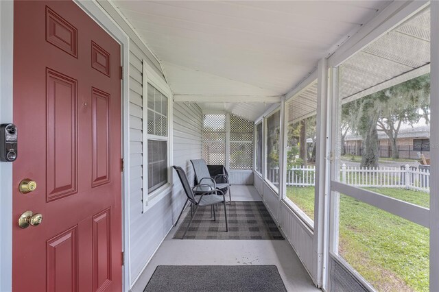 unfurnished sunroom with vaulted ceiling