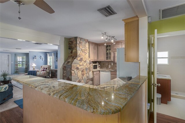 kitchen with plenty of natural light, light hardwood / wood-style floors, and kitchen peninsula