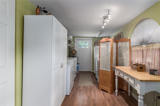 kitchen with light wood-type flooring, white cabinetry, and washer / clothes dryer