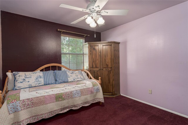 bedroom with dark colored carpet and ceiling fan