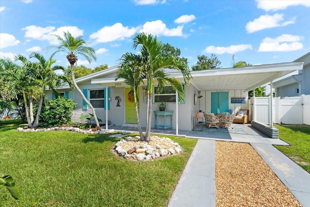 rear view of property featuring a yard