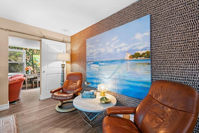 living area with light hardwood / wood-style floors and a water view