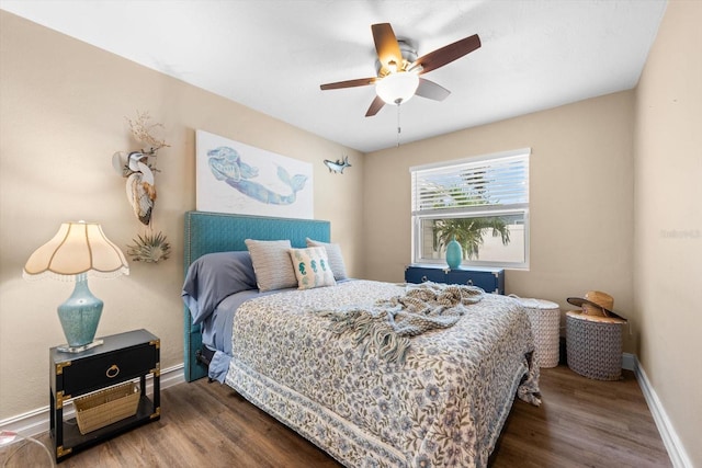 bedroom with ceiling fan and dark hardwood / wood-style floors