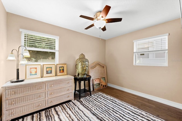 bedroom with ceiling fan and dark hardwood / wood-style flooring