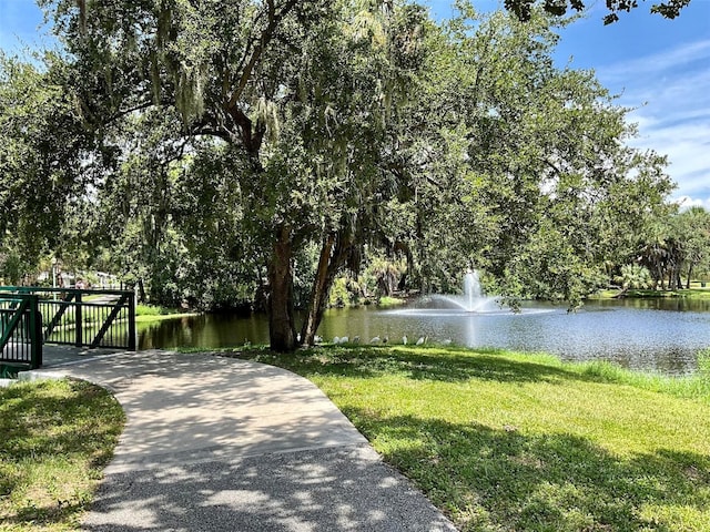 view of community featuring a yard and a water view