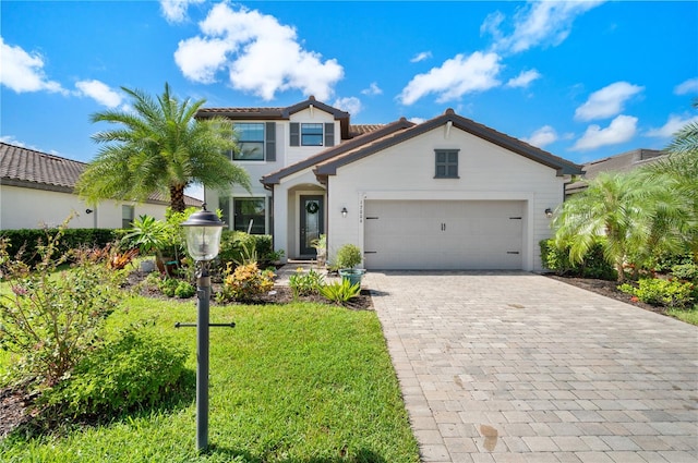 view of front of home featuring a garage and a front lawn