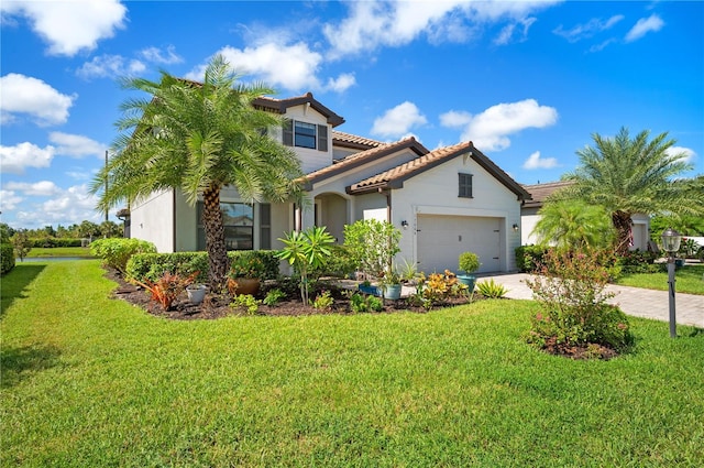 mediterranean / spanish-style home with a garage, a front yard, decorative driveway, and a tile roof