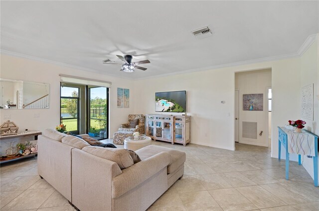 tiled living room featuring ceiling fan and ornamental molding