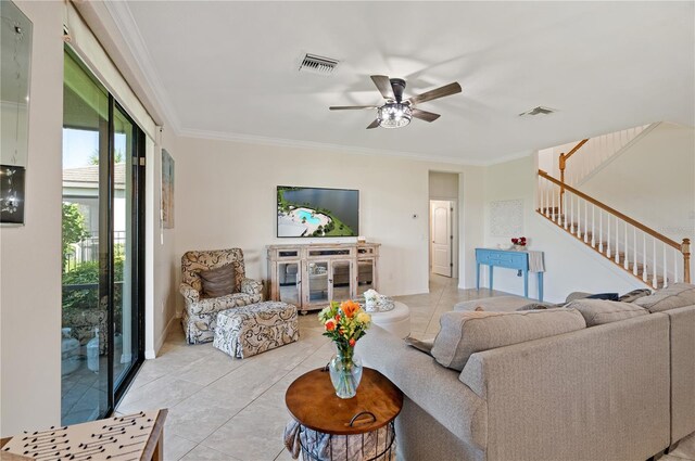 living room featuring ceiling fan, light tile patterned flooring, and ornamental molding