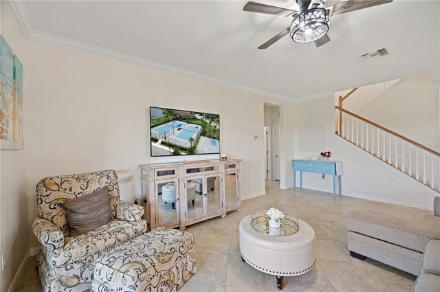 living room with ceiling fan, light tile patterned floors, and ornamental molding