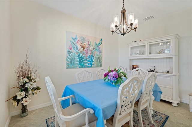 tiled dining area with a notable chandelier