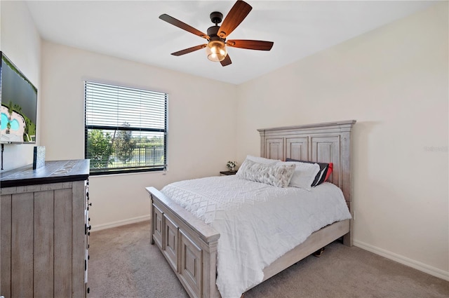 bedroom with ceiling fan and light colored carpet