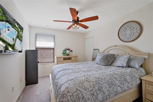 carpeted bedroom featuring a closet and ceiling fan