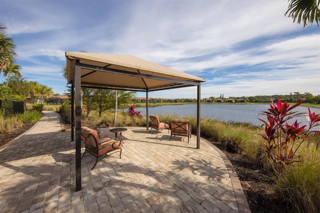 view of patio / terrace with a water view, a gazebo, and a fire pit