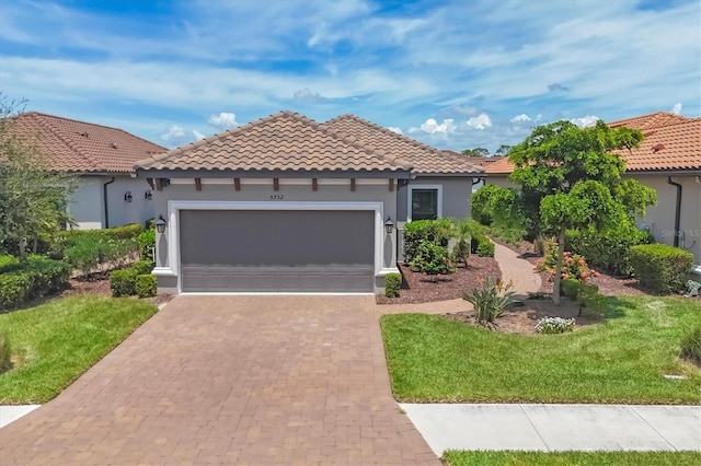5732 Puccini St, Nokomis, FL 34275 - mediterranean / spanish-style house featuring a garage, decorative driveway, a tile roof, and a front yard