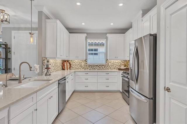 kitchen with light stone counters, decorative light fixtures, stainless steel appliances, white cabinetry, and sink