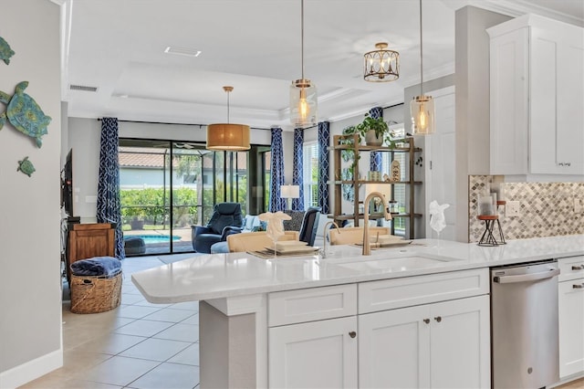 kitchen with sink, white cabinetry, decorative light fixtures, and stainless steel dishwasher