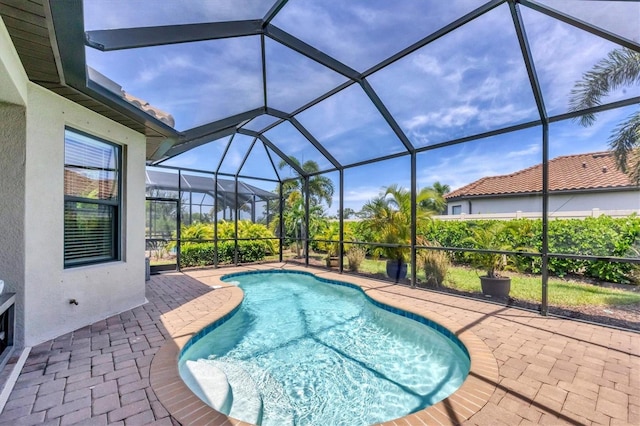 view of swimming pool with a lanai and a patio