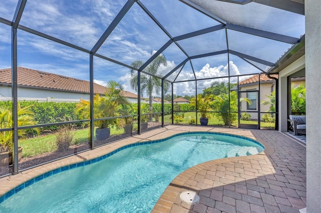 view of pool with a lanai and a patio