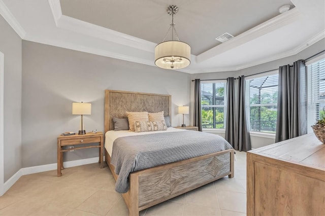 bedroom featuring crown molding, a tray ceiling, and light tile patterned floors