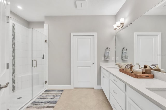 bathroom featuring vanity, tile patterned floors, and a shower with shower door