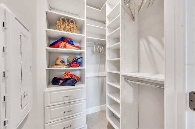 spacious closet featuring light tile patterned floors