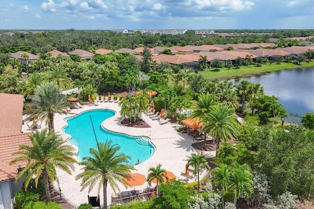 view of pool featuring a patio area and a water view