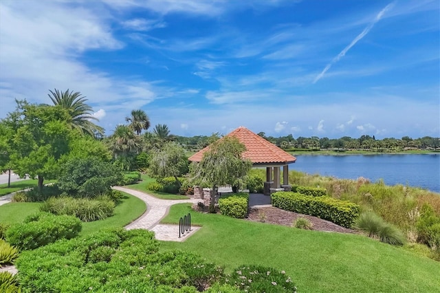 view of community with a yard and a water view