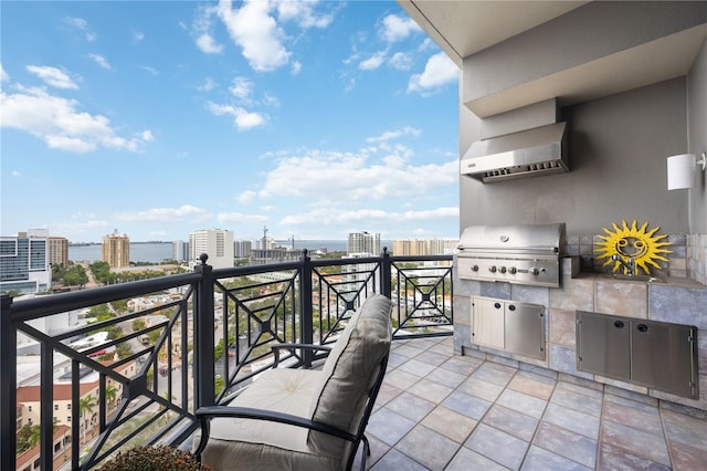 balcony with a grill and an outdoor kitchen