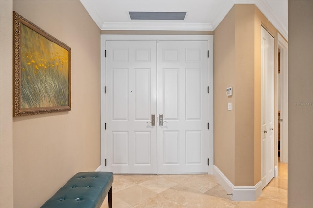 doorway to outside with crown molding and light tile patterned floors