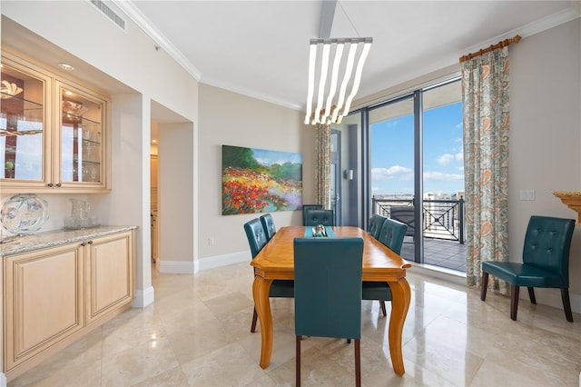 tiled dining space featuring crown molding