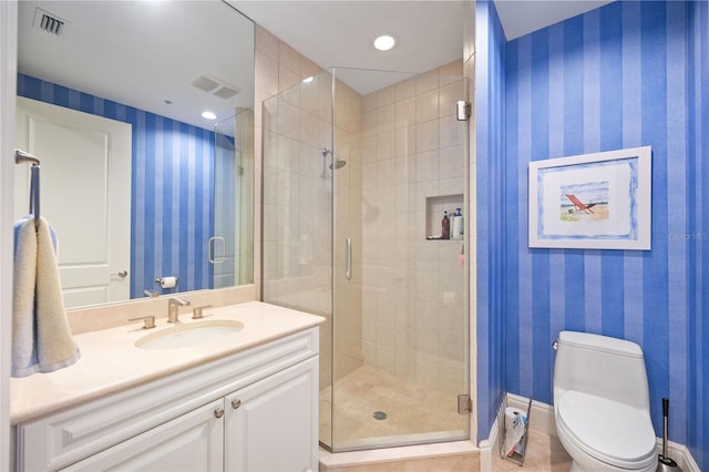 full bathroom with a stall shower, vanity, toilet, and wallpapered walls