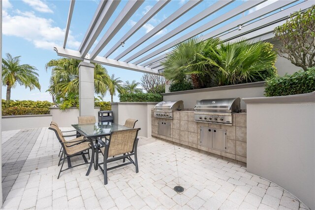 view of patio featuring a pergola, area for grilling, and an outdoor kitchen