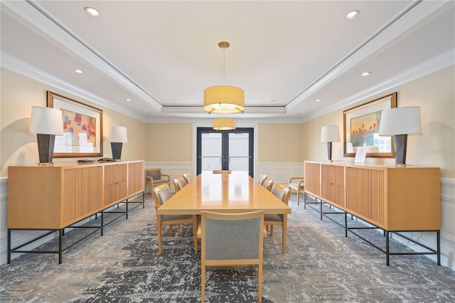 dining area featuring recessed lighting, a wainscoted wall, french doors, ornamental molding, and a raised ceiling