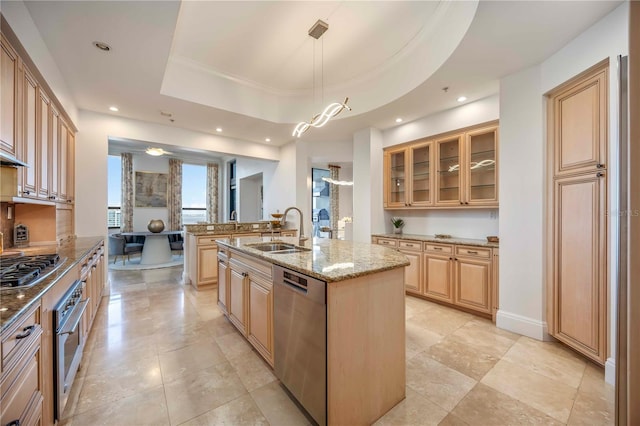 50 Central Ave Unit 17Phb, Sarasota, FL 34236 - kitchen with appliances with stainless steel finishes, an island with sink, light stone countertops, glass insert cabinets, and recessed lighting