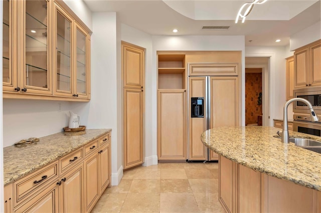 50 Central Ave Unit 17Phb, Sarasota, FL 34236 - kitchen with built in appliances, light stone countertops, glass insert cabinets, recessed lighting, and light tile patterned floors