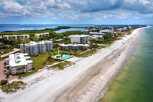 birds eye view of property featuring a beach view and a water view