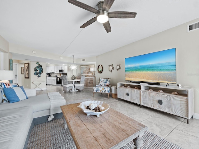 living room featuring ceiling fan and light tile patterned floors