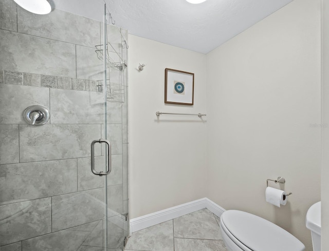 bathroom with tile patterned floors, a shower with shower door, and toilet