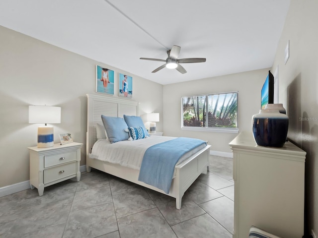 bedroom with ceiling fan and light tile patterned floors